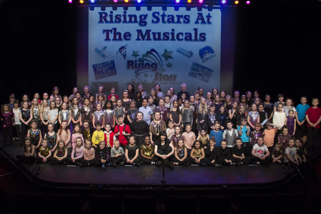 A photo of Rising Stars Theatre group on stage in Peterborough